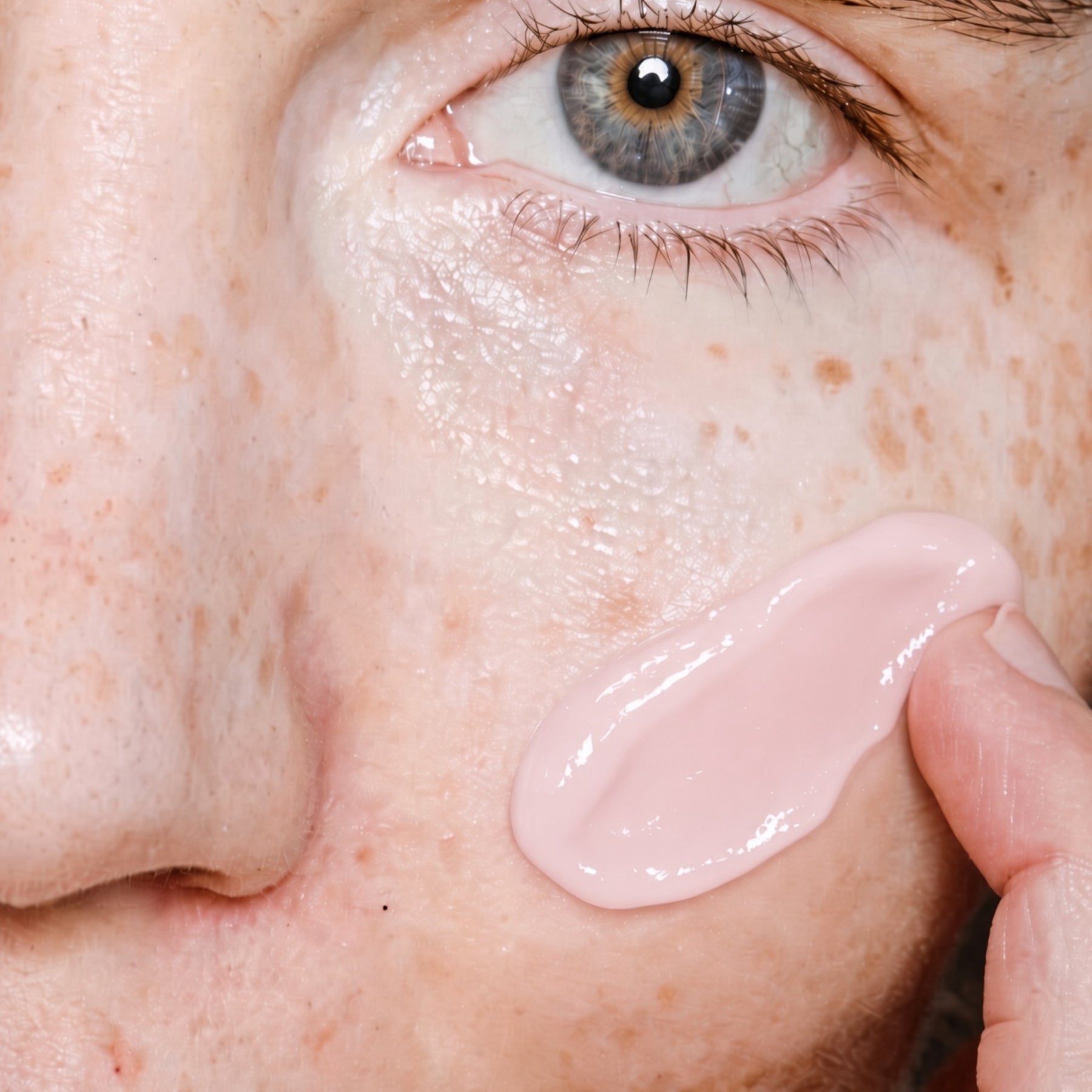 A female model applying Saint Mary's Youth Peptide Serum