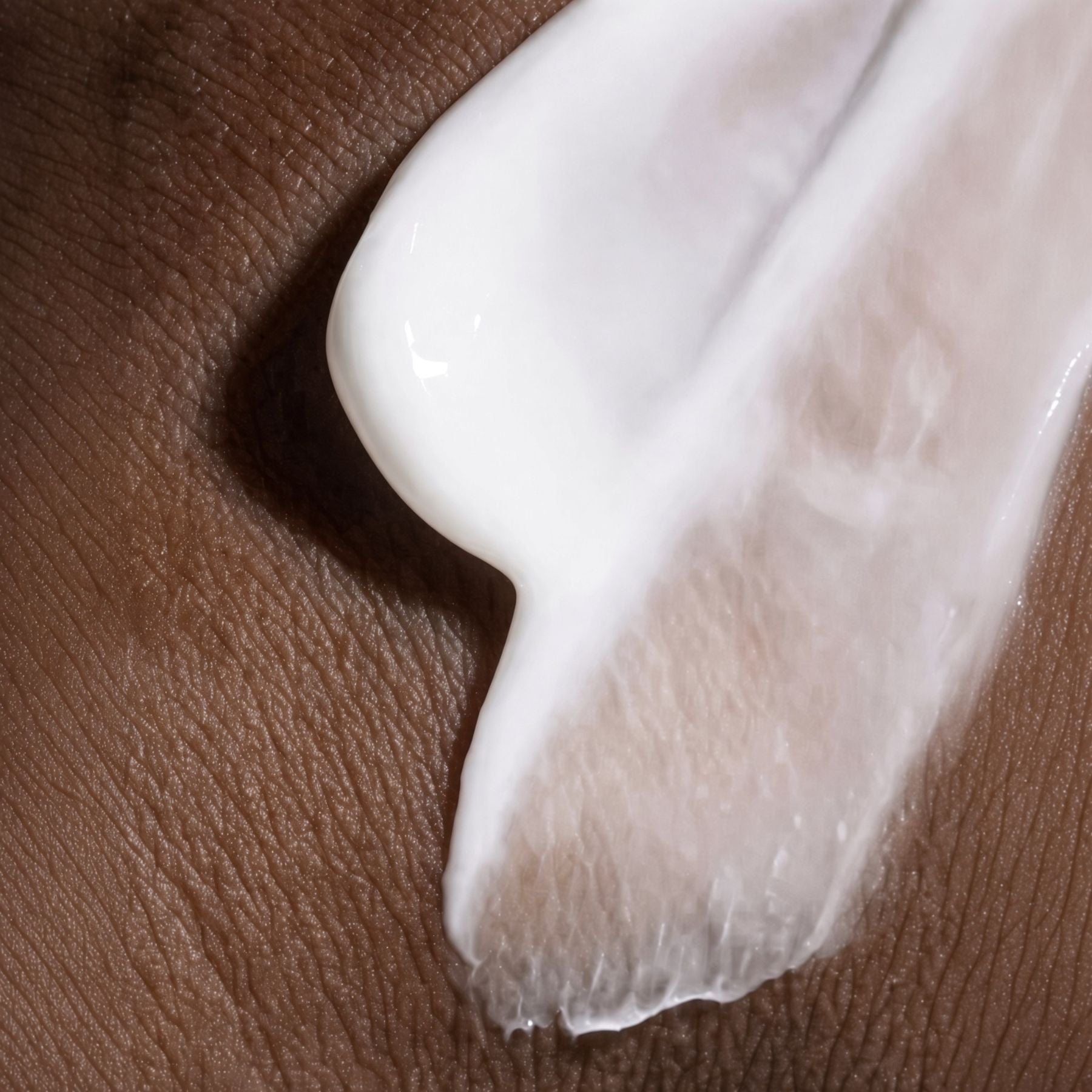 saint raphael body cream for men with urea and panthenol applied to dark skin