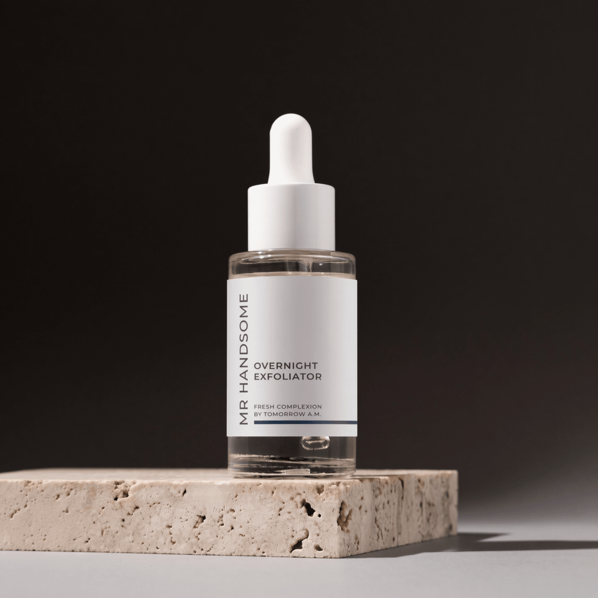 Overnight Exfoliator by MR HANDSOME standing on a stone plate